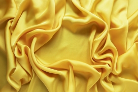 褶皱的黄袍色布匹图片