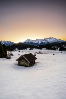 冬季黄昏下的小木屋风景图