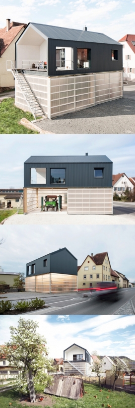 半透明底座的黑房屋建筑-德国Fabian Evers建筑工作室作品-坐落在靠近德国蒂宾根，半透明区域可以放卡车，可以居住又适合车间需要，不透明的波纹包层覆盖第一楼的墙壁和屋顶，四周是半透明的聚碳酸酯，使日光渗透到车间。白天的工作空间充满了过滤的自然光线