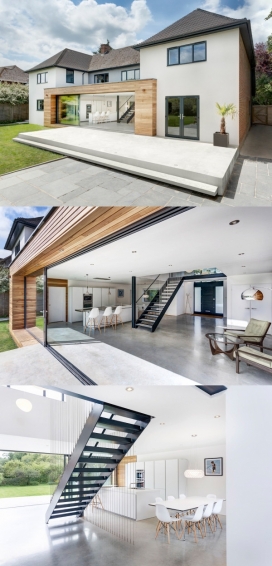 跑步者的房子-一个简约的家坐落在英格兰温彻斯特郊区林荫小道旁，曾经是一个古老的建筑，现在修建成现代时尚玻璃面板住宅，设计师将厨房，用餐区，生活区利用楼梯间空间融在一起，直接打通了室内和室外之间的边界