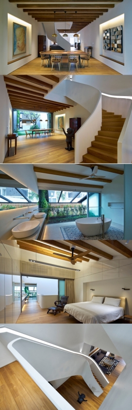 温暖的家-一个内部的庭院，带来了阳光和自然通风的家，院子的一边，有一个客厅和餐厅，还有一个巨大的楼梯，涵盖所有三个层房屋