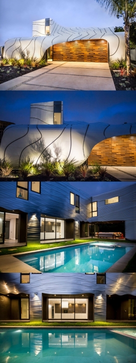 一个大型波状外观的房子-横跨5,700平方英尺，设有五间卧室和四间浴室，配有一系列有机设计的地板和墙壁，与起伏的外观一样让人视觉上令人着迷。波浪般的白色铝立面，模仿海洋膨胀，罗马诺的艺术背景就清晰地显现出来