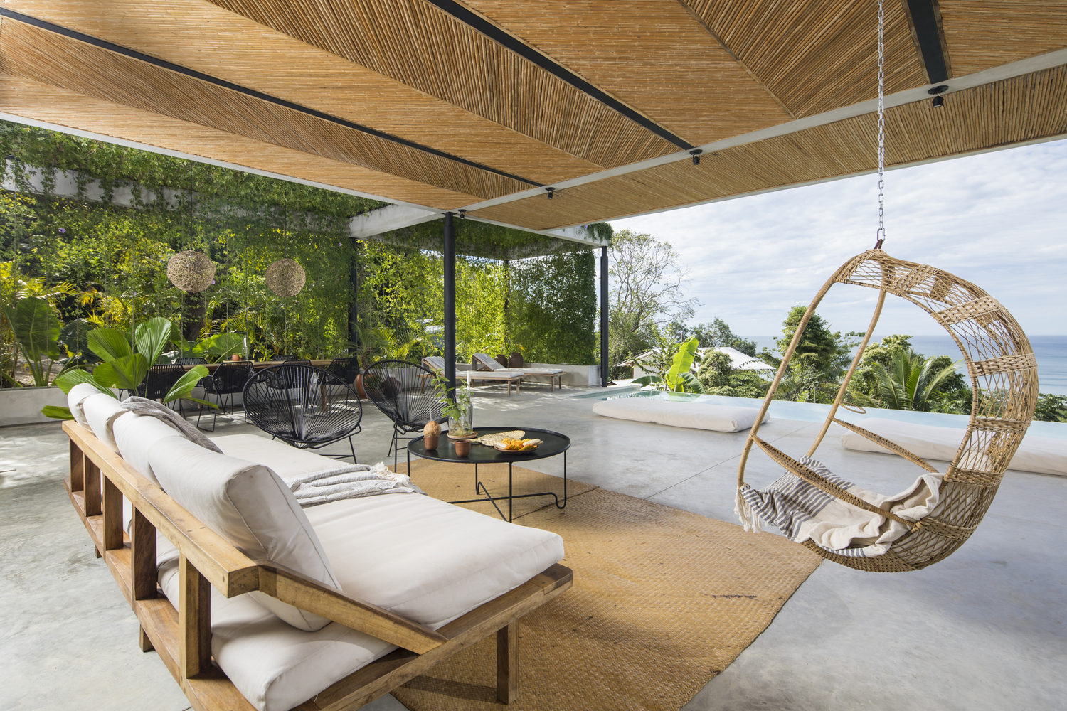酒店每个客房都是一个帐篷式样的结构,这样能后退产生一个私人空间,但同时又能与周边自然互动。宽敞的客房配有完全开敞的私人露台,前景是宽阔的海景,背景则是热带植被。甚至,浴室也享有开放的布局,使住客能在一边听着波涛汹涌的浪花声一边沐浴。每间客房都提供了一个屋顶露台,内设郁郁葱葱的灌木植株、一个遮荫帐篷顶,还有配套的藤条家具。这些藤条家具产自一个以土著居民手工著称的哥斯达黎加小镇 Sarchí。热带度假酒店的建筑设计师在整个项目中都坚持当地取材。比如,天花板的材料是一种名为“caña brava”的玻璃,安装在错综复杂的鱼骨图案中。当地工匠还通过活用传统工艺,打造了定制的木制家具。