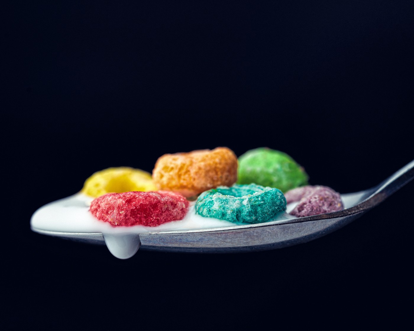 勺子中融化的五彩糖果图片