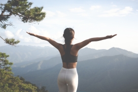 高山下做瑜伽运动的背部女性