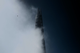 被白色浓雾遮盖的尖角高楼大厦